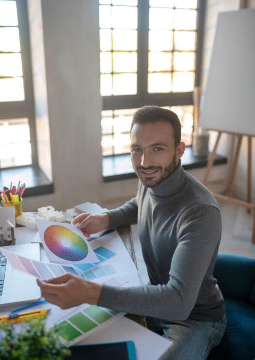 Designer feeling good. Smiling interior designer feeling good while working on new project